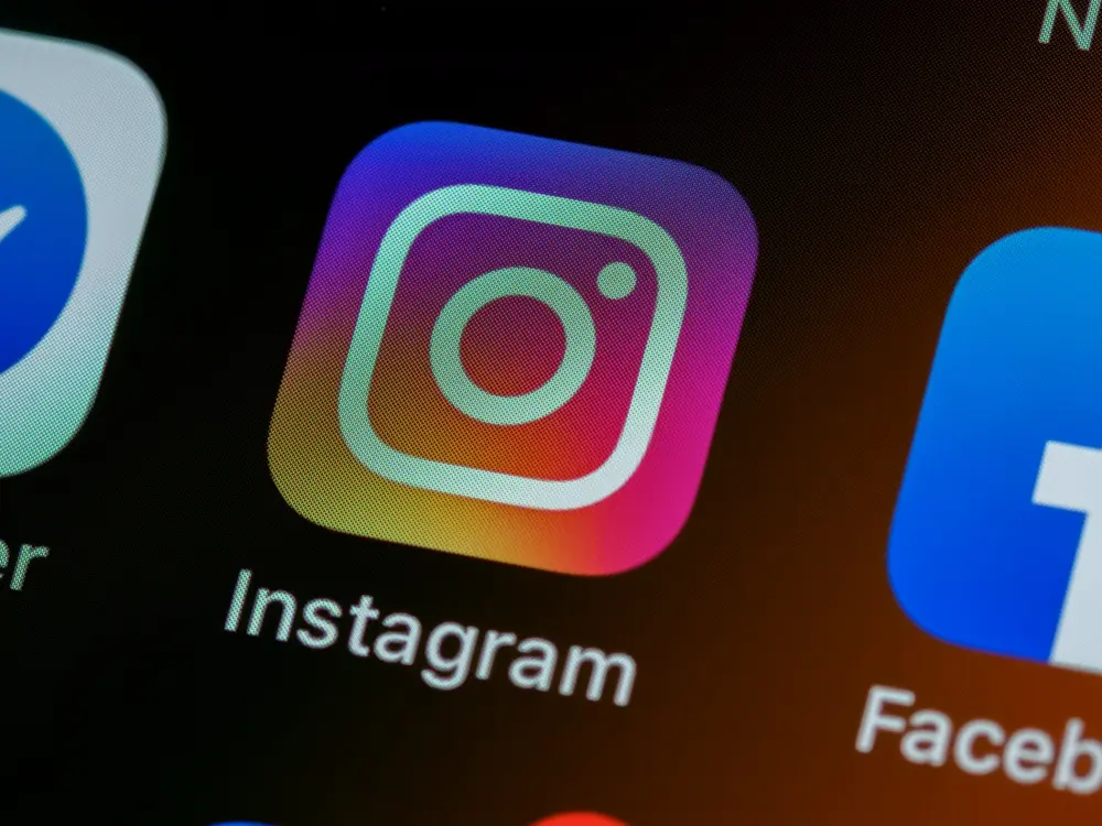 Instagram app icon on a phone screen, illustrating an Instagram shadowban