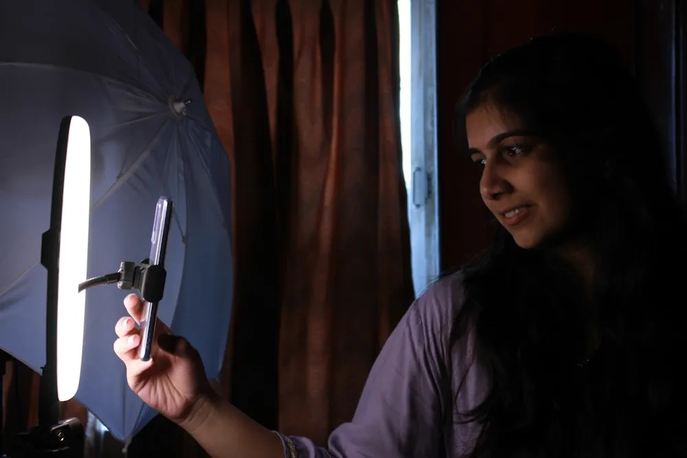 Person filming a Reel with a ring light to grow free Instagram followers