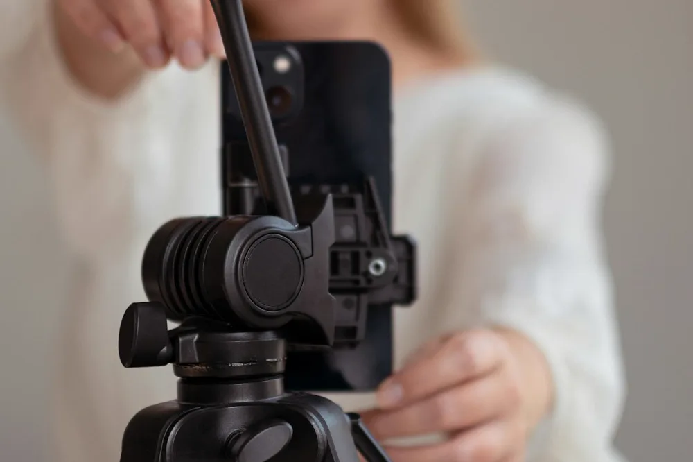 Creator setting up a phone on a tripod: bought Instagram likes and reach