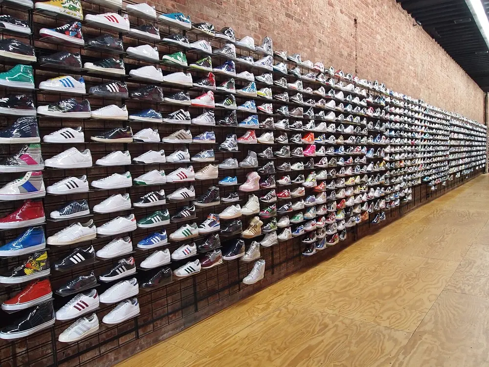 Wall of sneakers on display in a New York City shoe store, illustrating streetwear and sneaker culture on Instagram