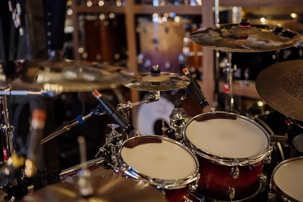 Drum kit with cymbals and studio microphones set up for a session, illustrating live drumming content on Instagram in the US