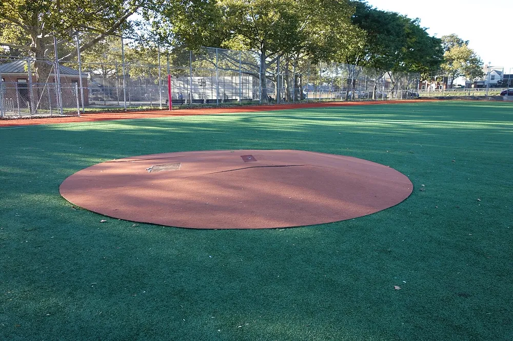 Empty pitcher's mound on a public park baseball field in New York, illustrating professional baseball content on Instagram in the US