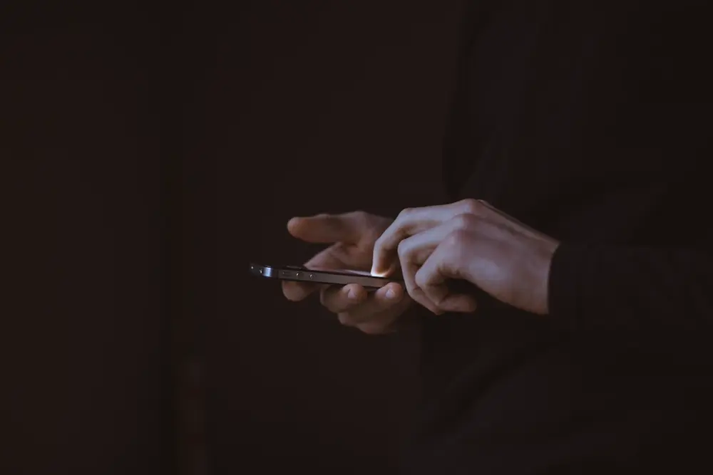 Person checking whether their bought Instagram followers dropped, illustrating InfluCheap's replacement guarantee